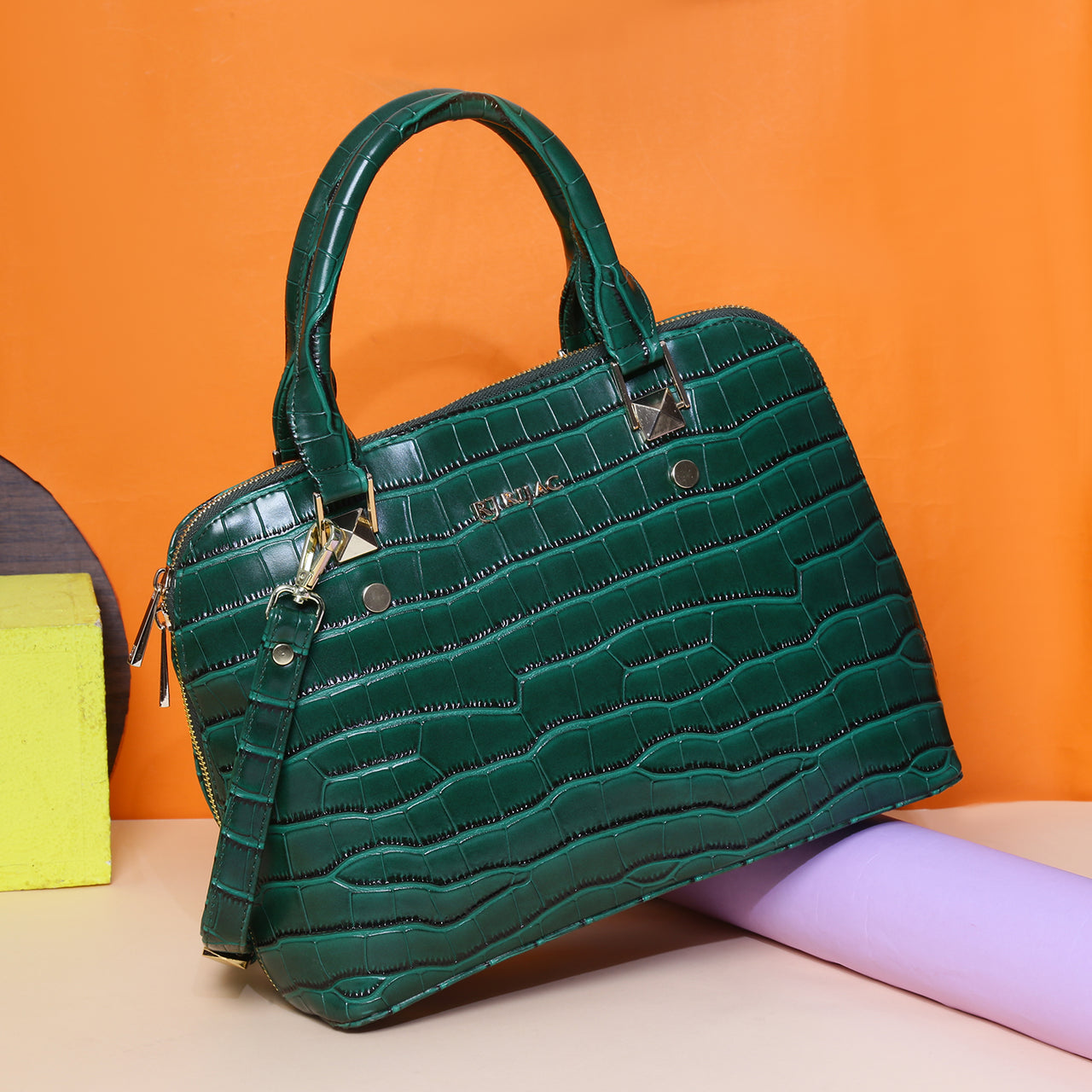 A green handbag on a colorful background.